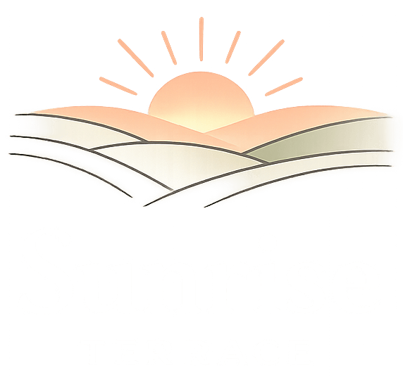 An open book with a sun rising behind it and clouds below.
